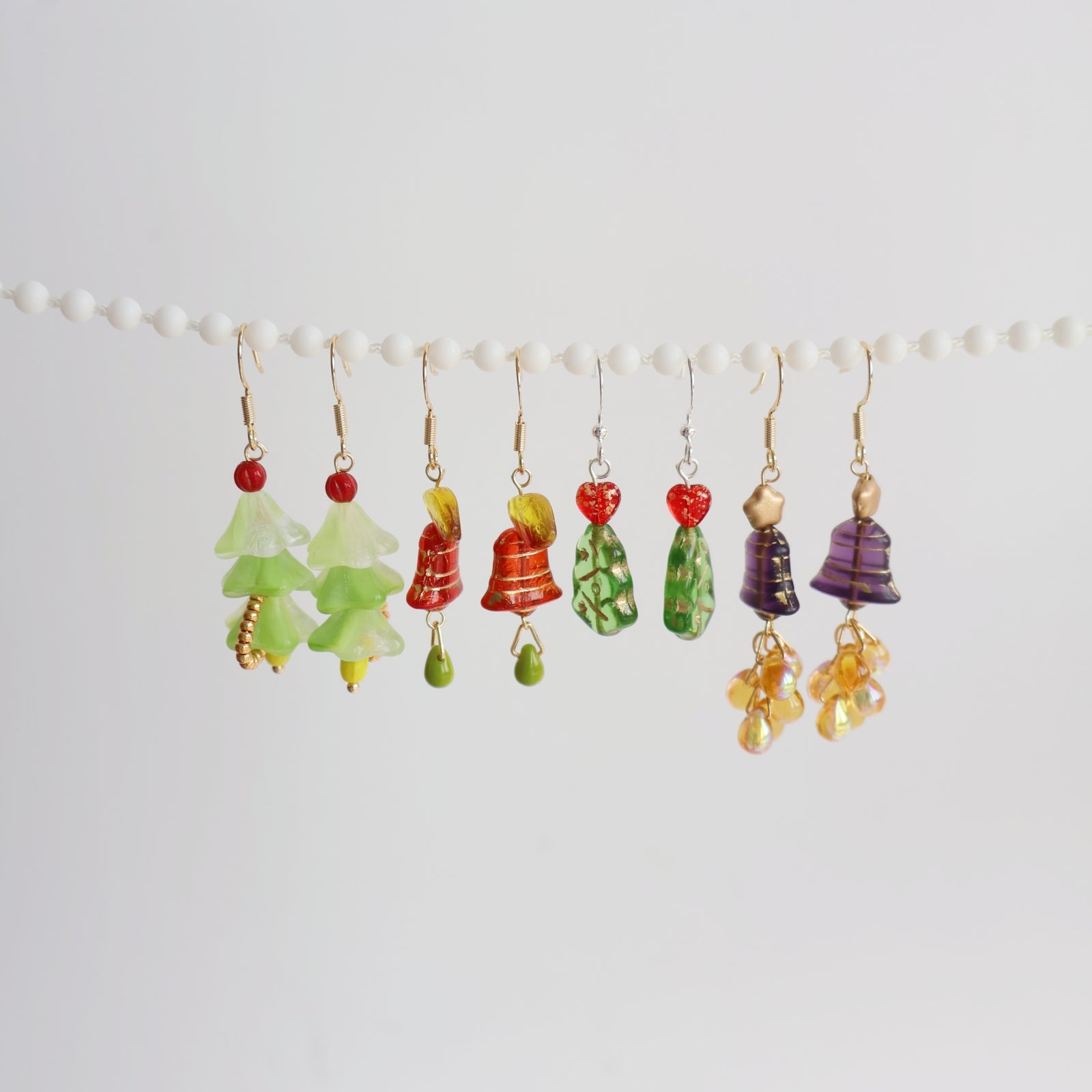 Colorful earrings hanging on a white background