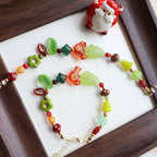 Colorful beaded necklace on a white surface with a wooden frame