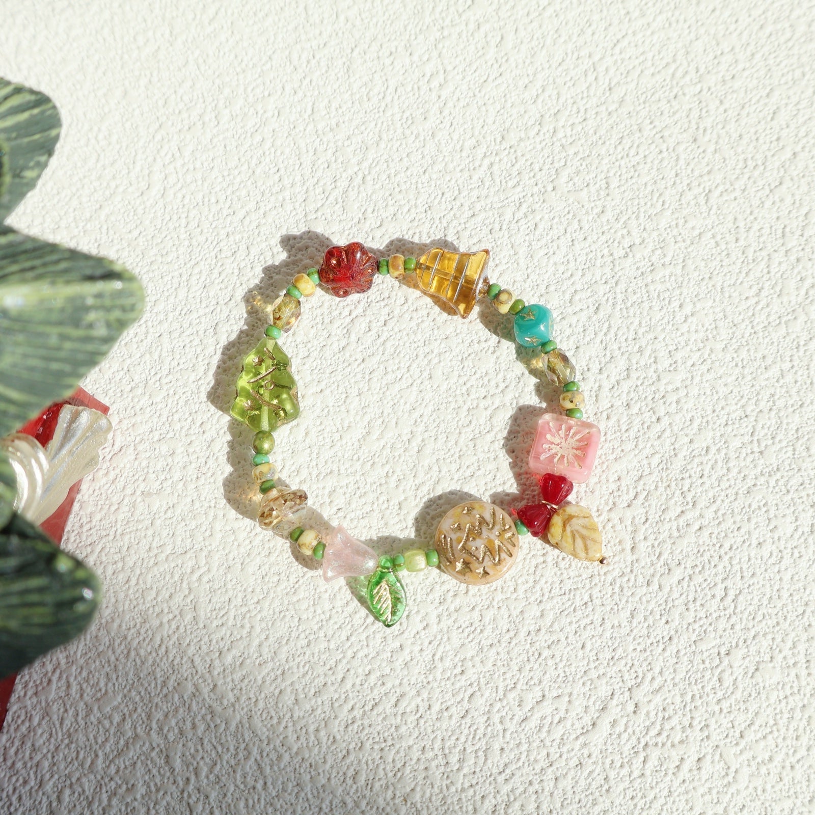 Colorful beaded bracelet on a textured white surface
