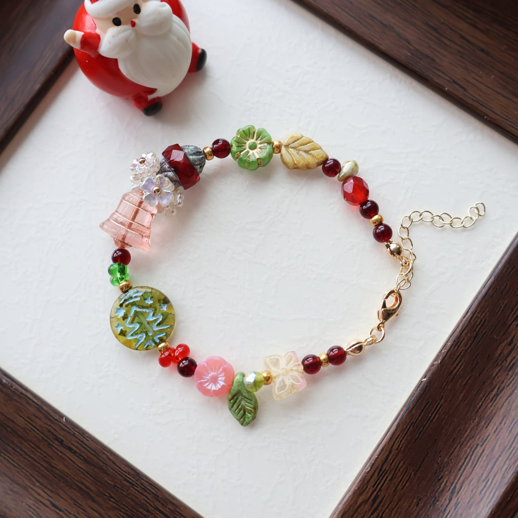 Colorful beaded bracelet on a white surface with a small figurine in the background