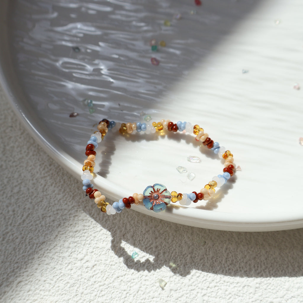 Colorful beaded bracelet on a textured white surface