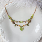 Necklace with heart-shaped pendant on a textured white surface