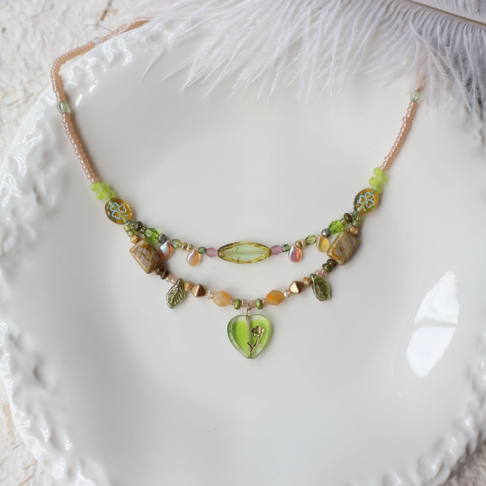 Necklace with heart-shaped pendant on a textured white surface