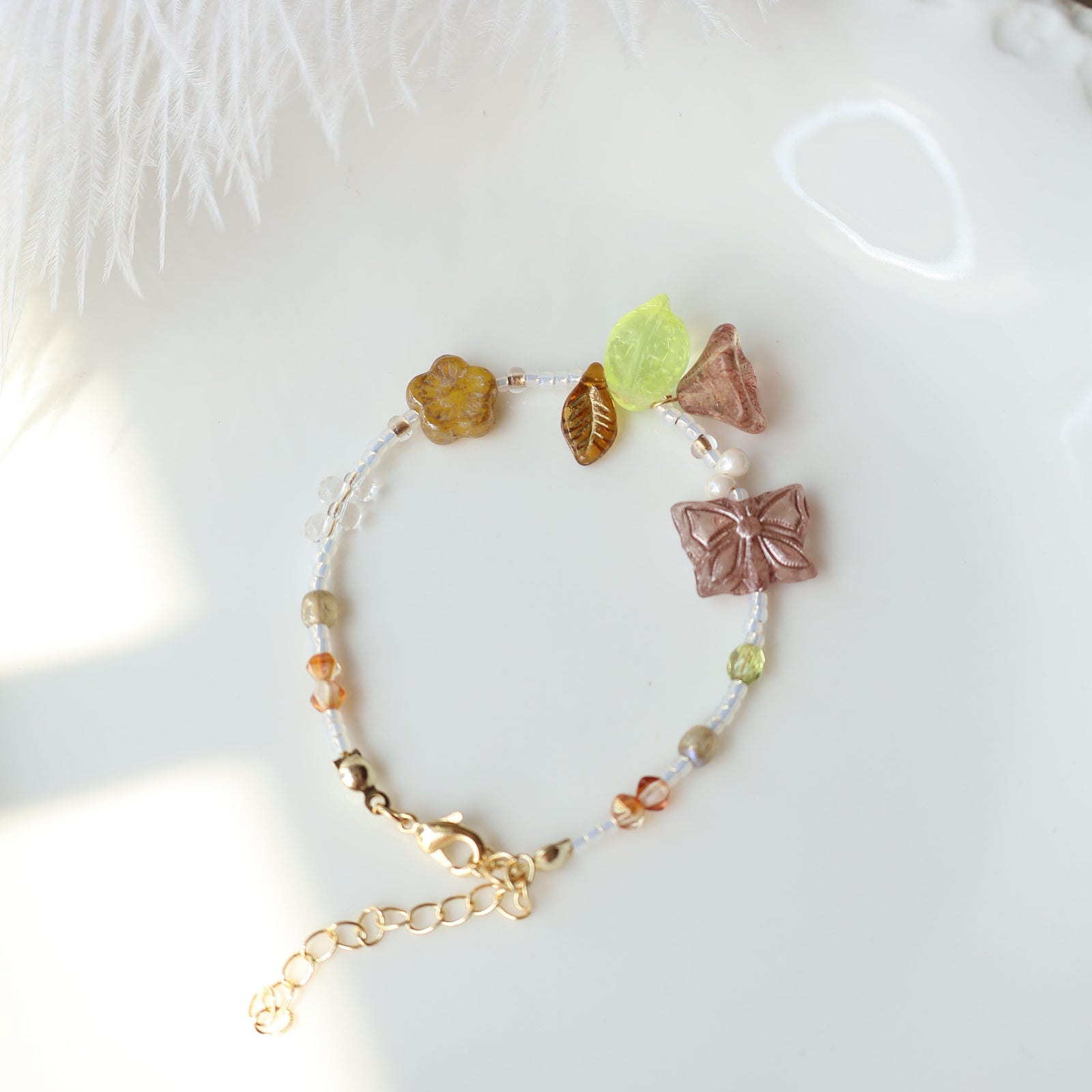 Bracelet with leaf-shaped beads on a soft white background