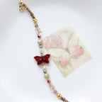 Bracelet with butterfly charm on a white background