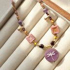 Necklace with colorful beads on a beige jewelry box