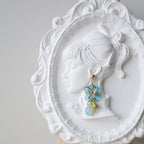 Decorative brooch with blue stones on a white decorative plate