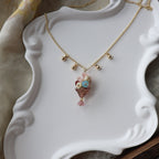 Necklace with a decorative pendant on a white decorative stand