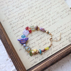 Colorful beaded necklace on a piece of paper with text