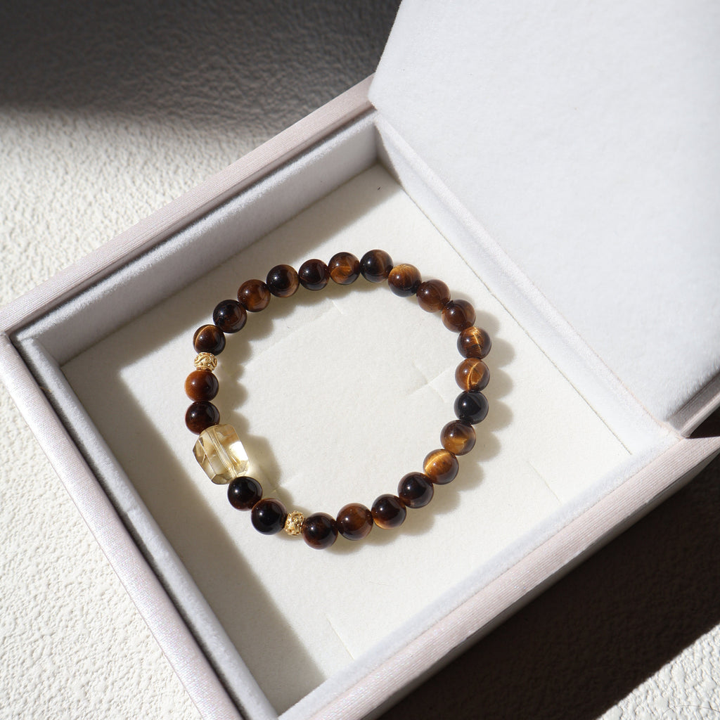 Beaded bracelet with a clear crystal on a white box