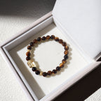 Beaded bracelet with a clear crystal on a white box