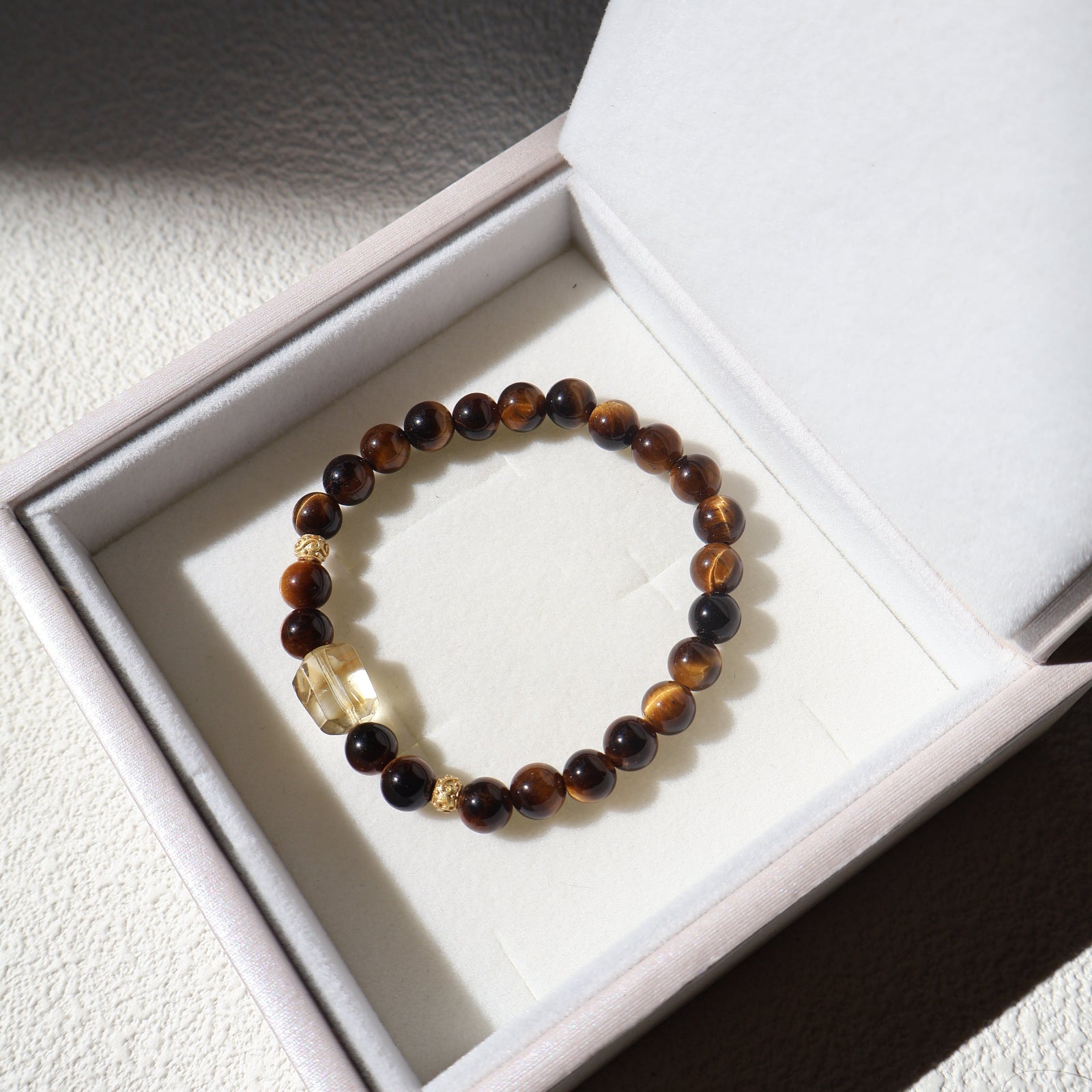 Beaded bracelet with a clear crystal on a white box