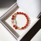 Red beaded bracelet with a clear crystal charm in a white box