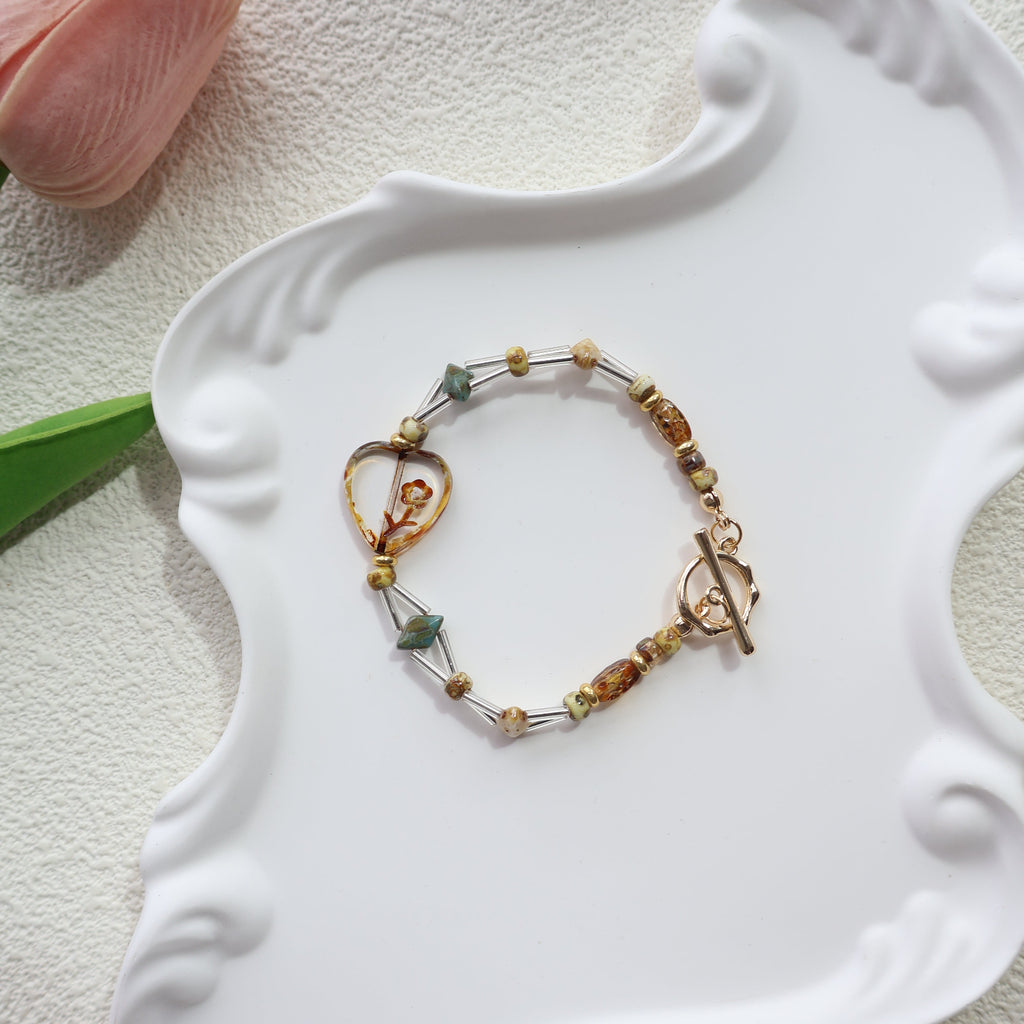 Bracelet with multicolored beads on a white decorative dish