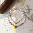 Stack of pearl necklaces on an old letter with floral designs