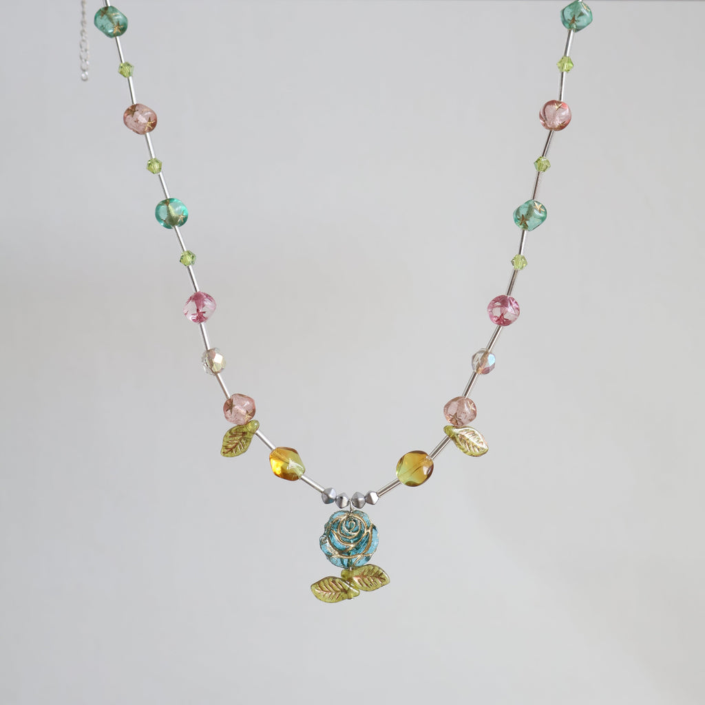 Necklace with multicolored beads on a light gray background