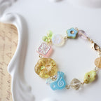 Colorful beaded bracelet with various charms on a white surface