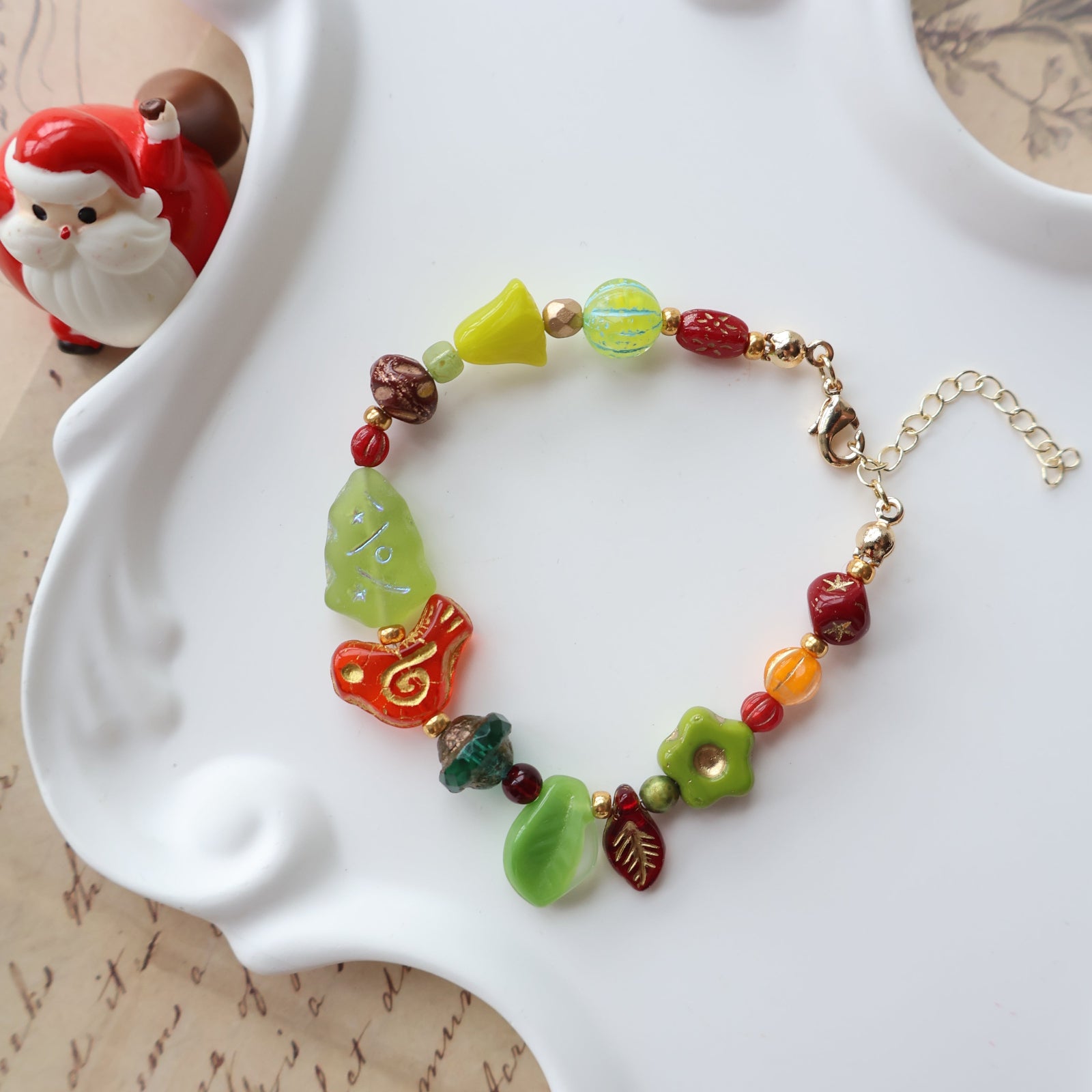 Colorful beaded bracelet on a white surface with a decorative background