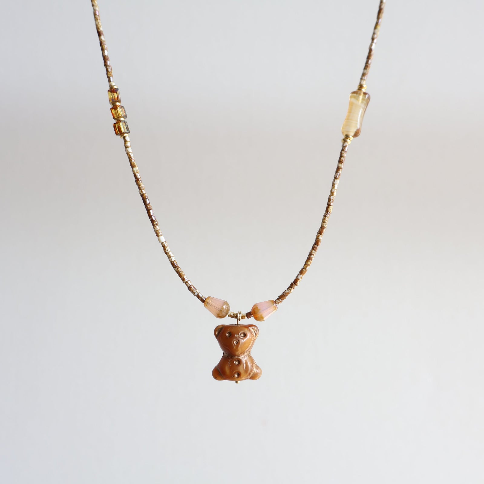Necklace with a bear-shaped pendant on a light gray background
