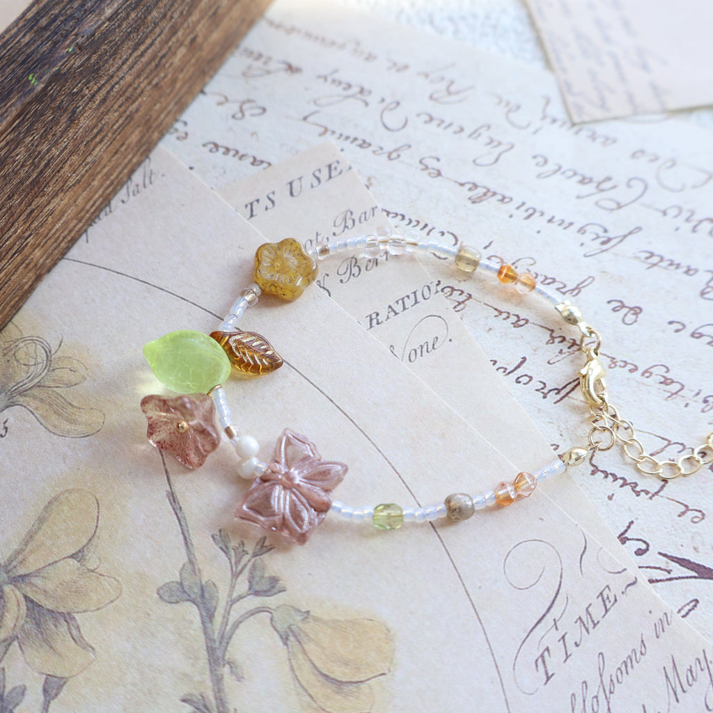 Bracelet with floral beads on a vintage letter background