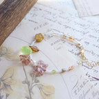 Bracelet with floral beads on a vintage letter background