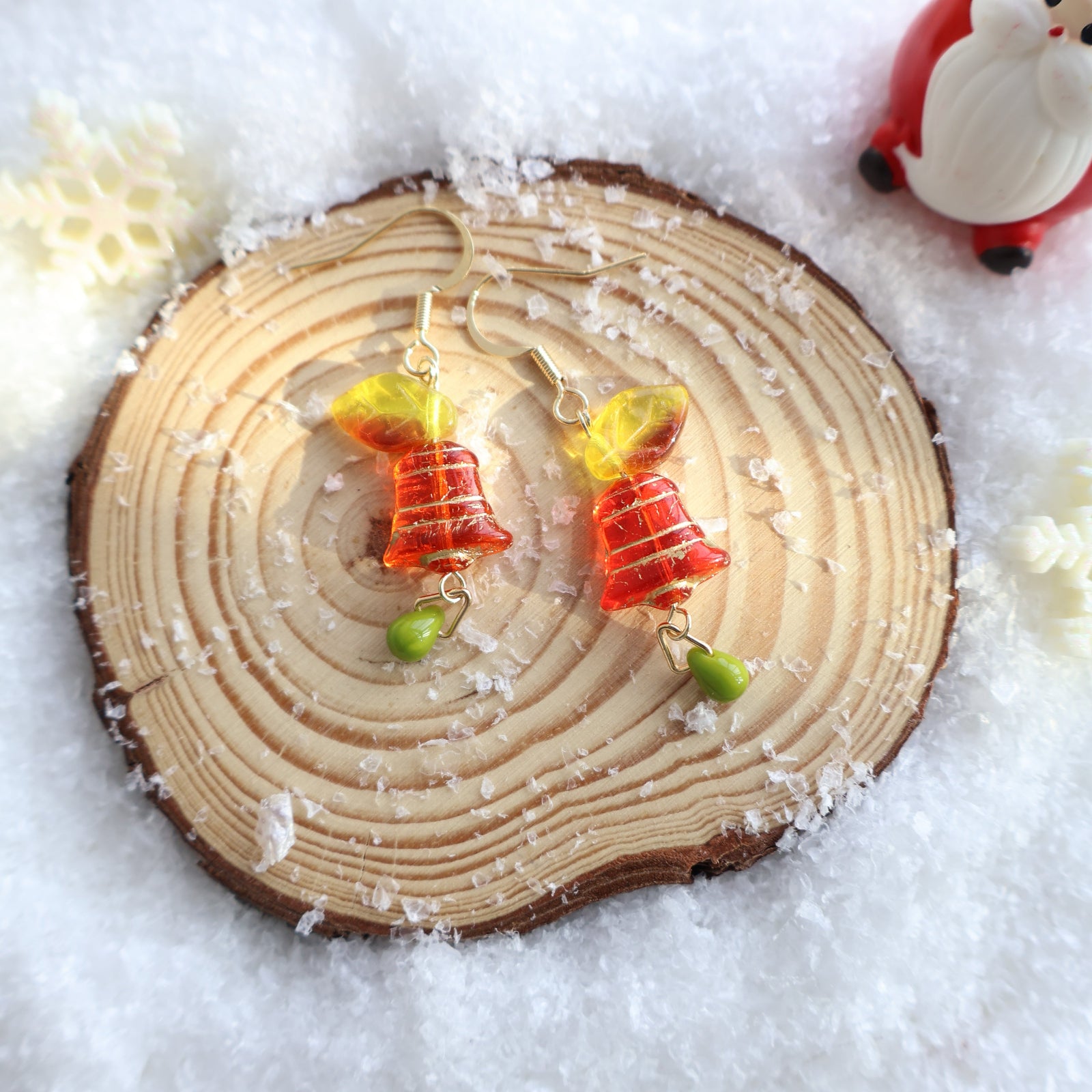 Wooden ornament with colorful fish design on a snowy background