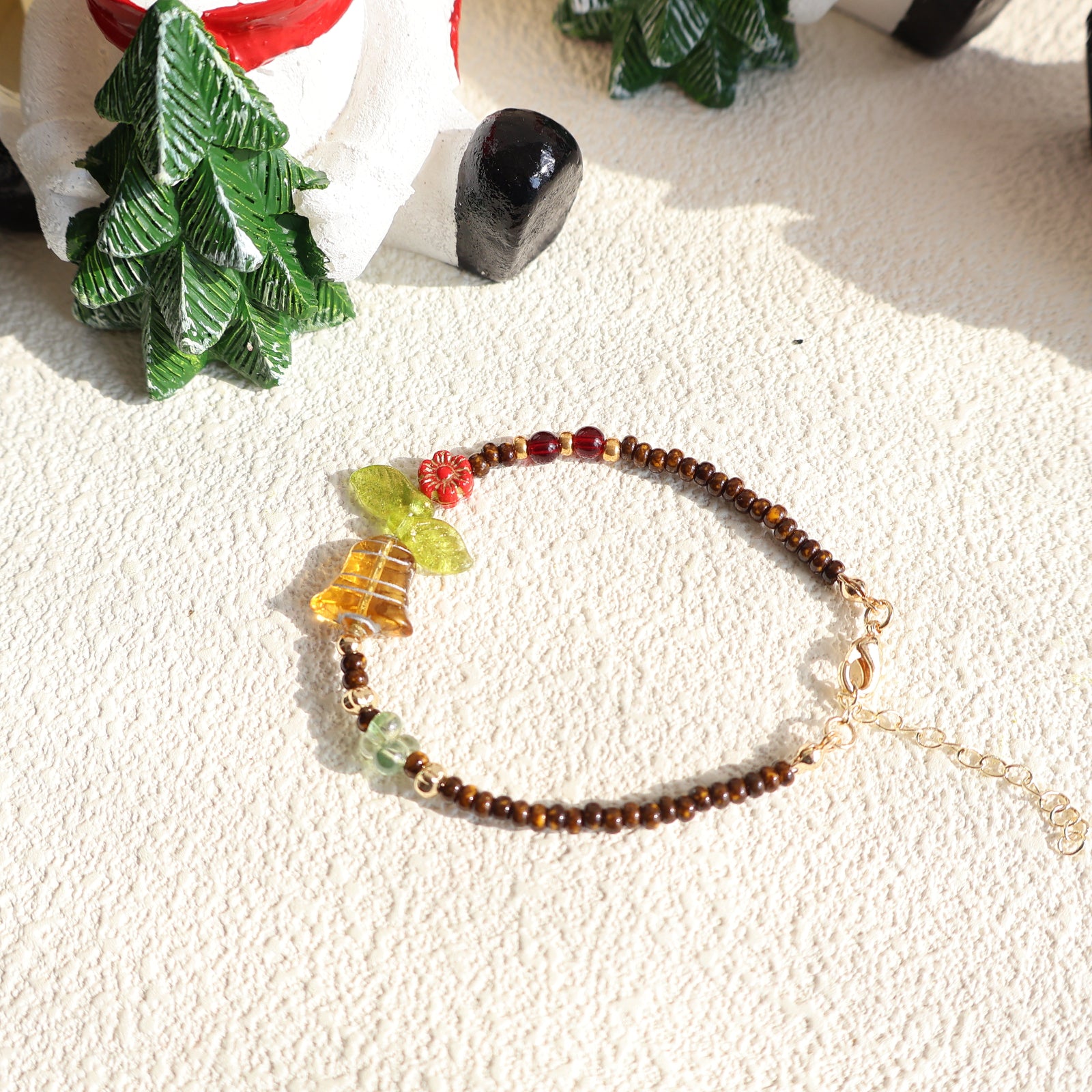 Beaded bracelet with decorative elements on a textured surface