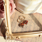 Heart-shaped keychain with dice on a sheet of music with a gold frame