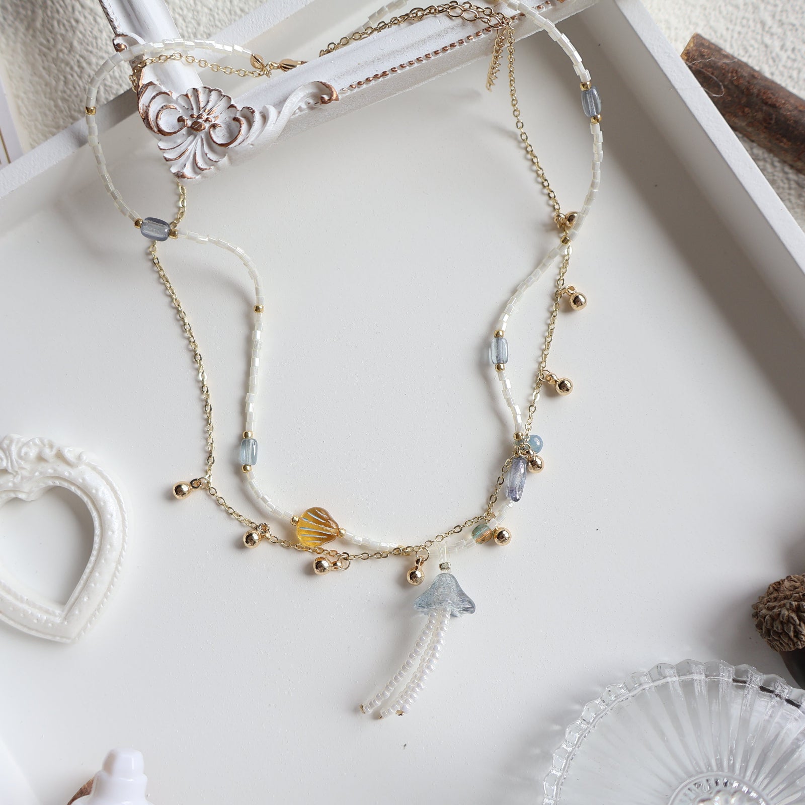 Necklace with decorative elements on a white surface