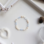 Beaded bracelet on a white surface with decorative elements