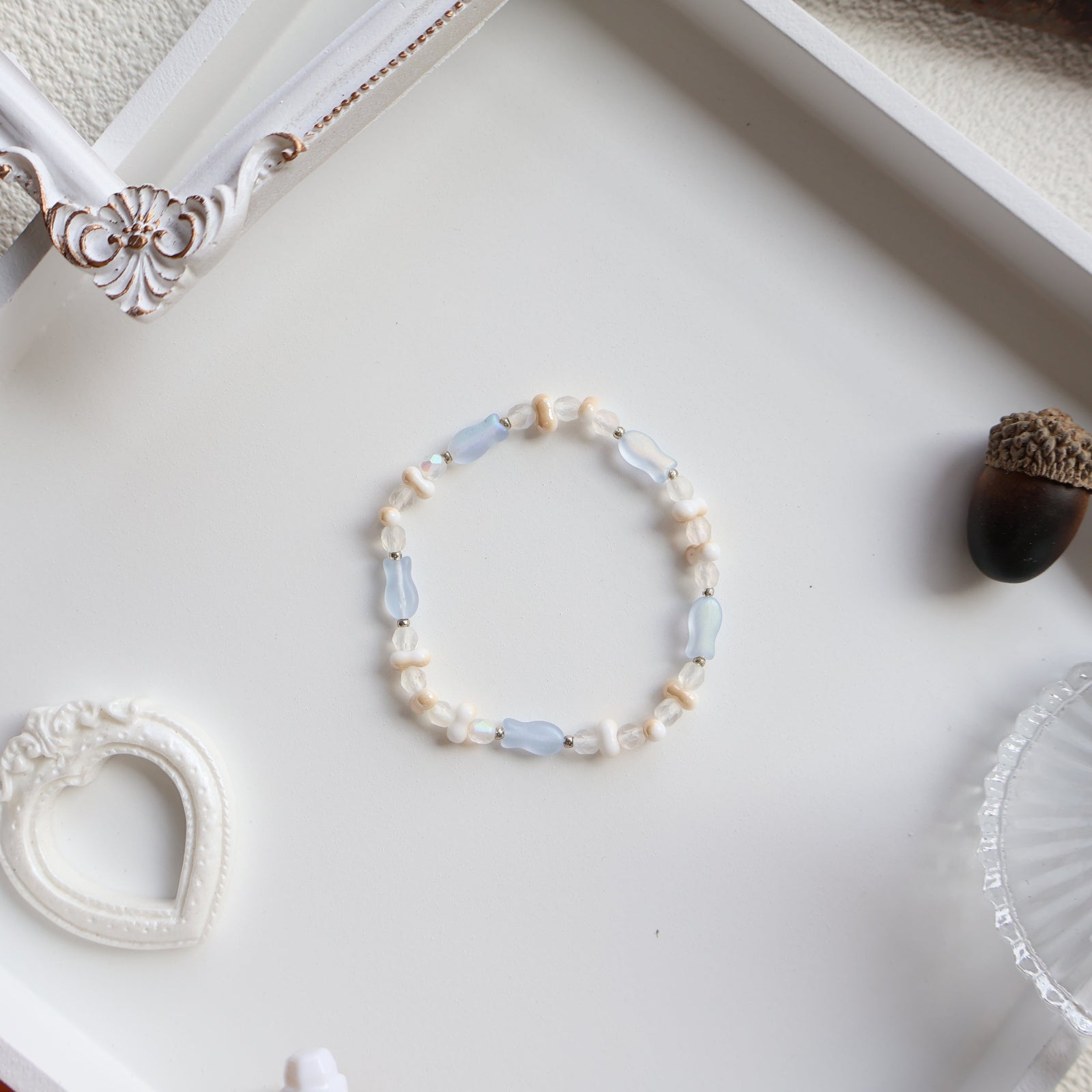 Beaded bracelet on a white surface with decorative elements