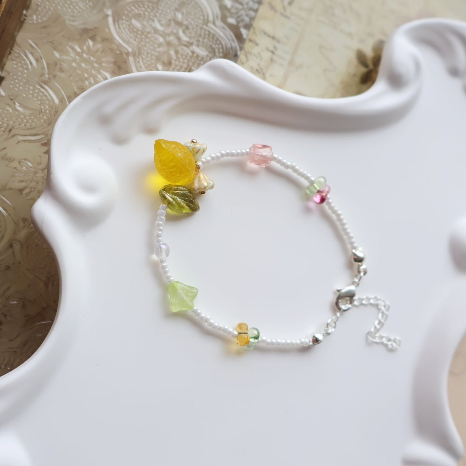 Bracelet with colorful beads on a decorative white surface