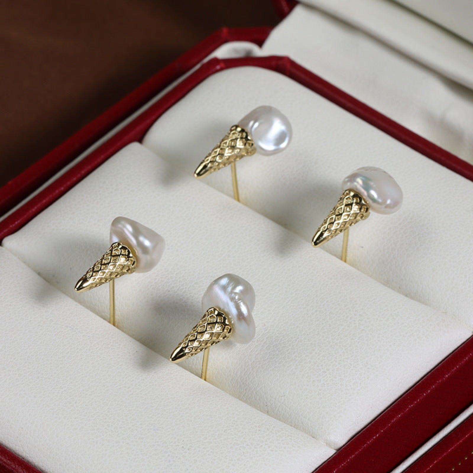 Gold and pearl earrings in a jewelry box