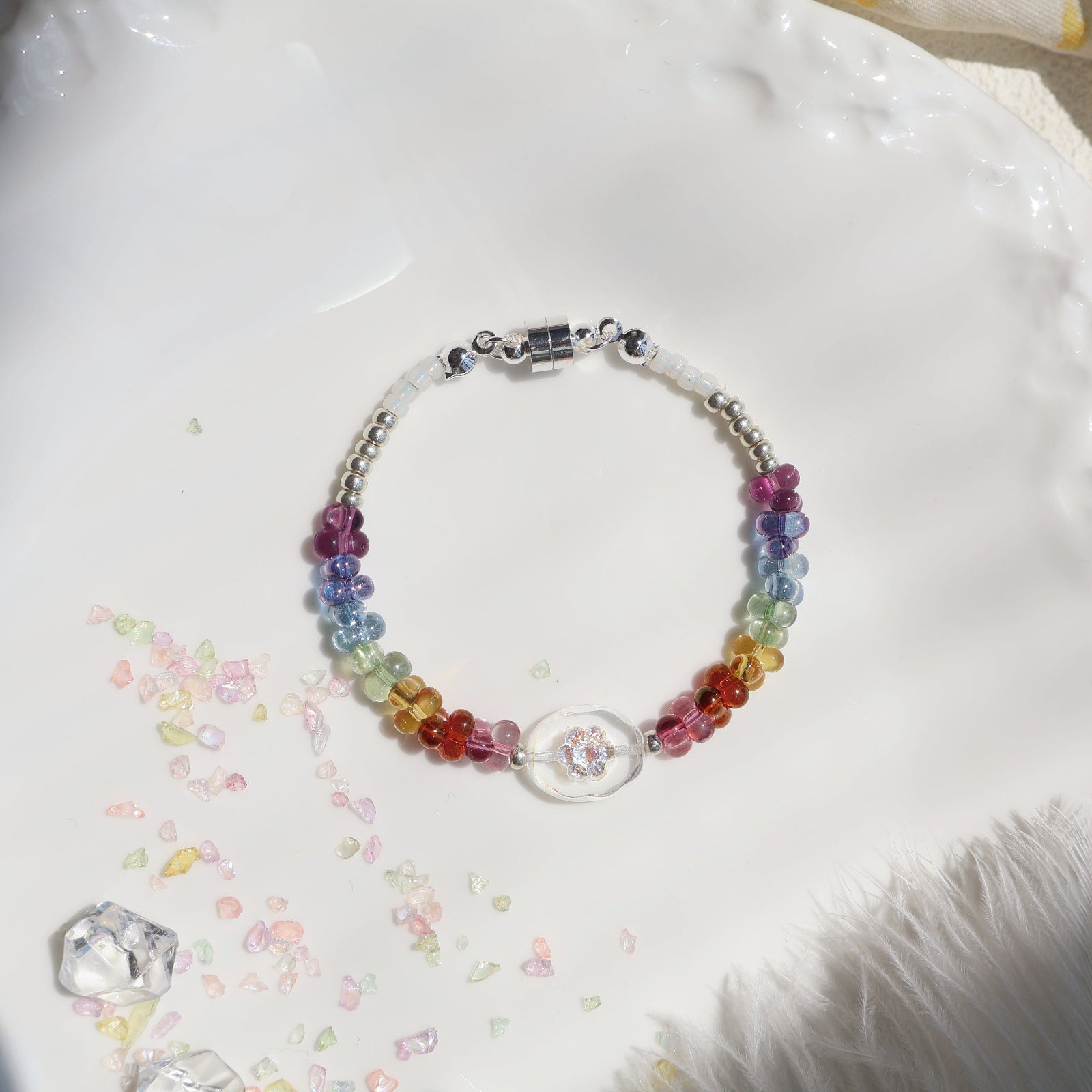 Multicolored beaded bracelet on a white surface with decorative elements