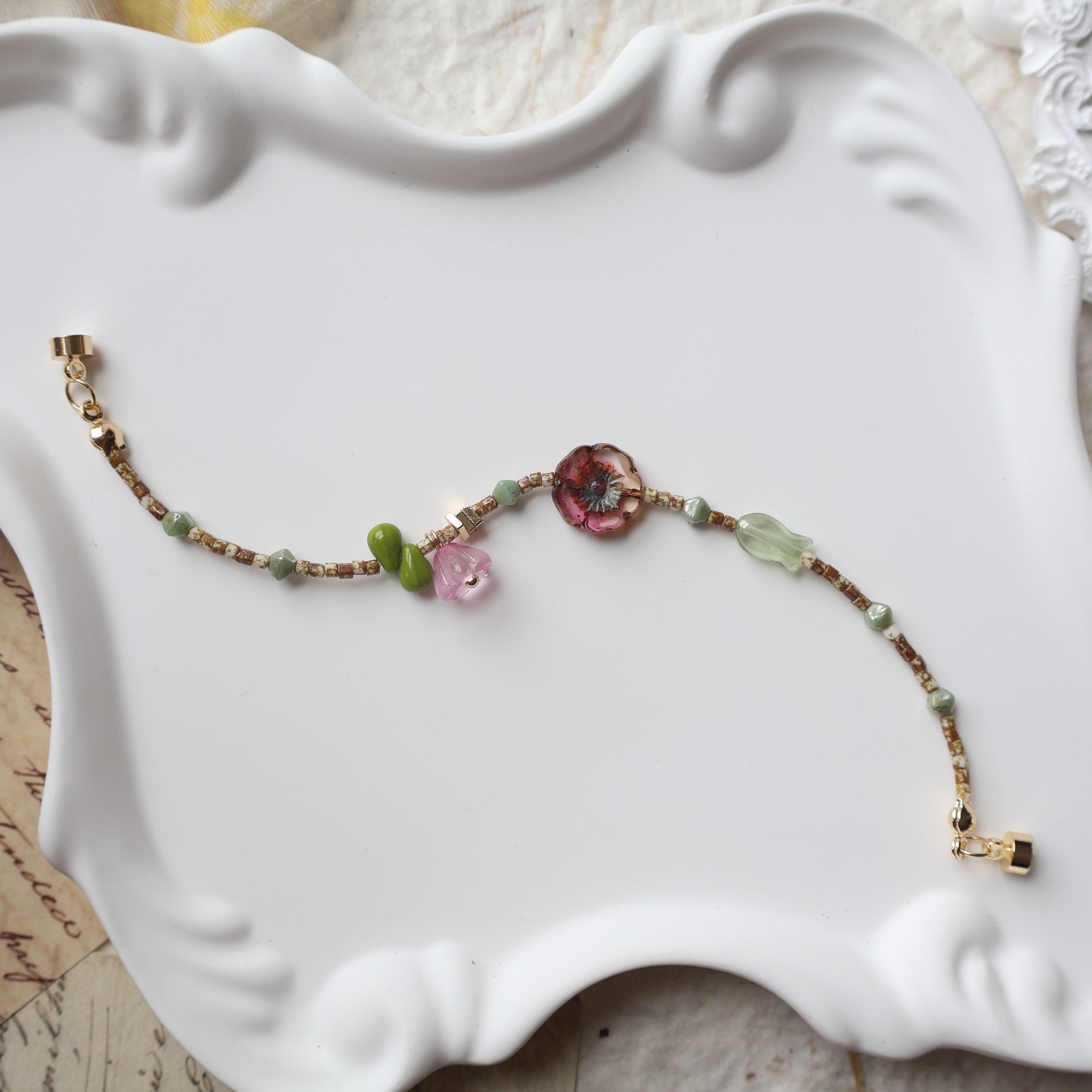 Colorful beaded bracelet on a decorative white plate