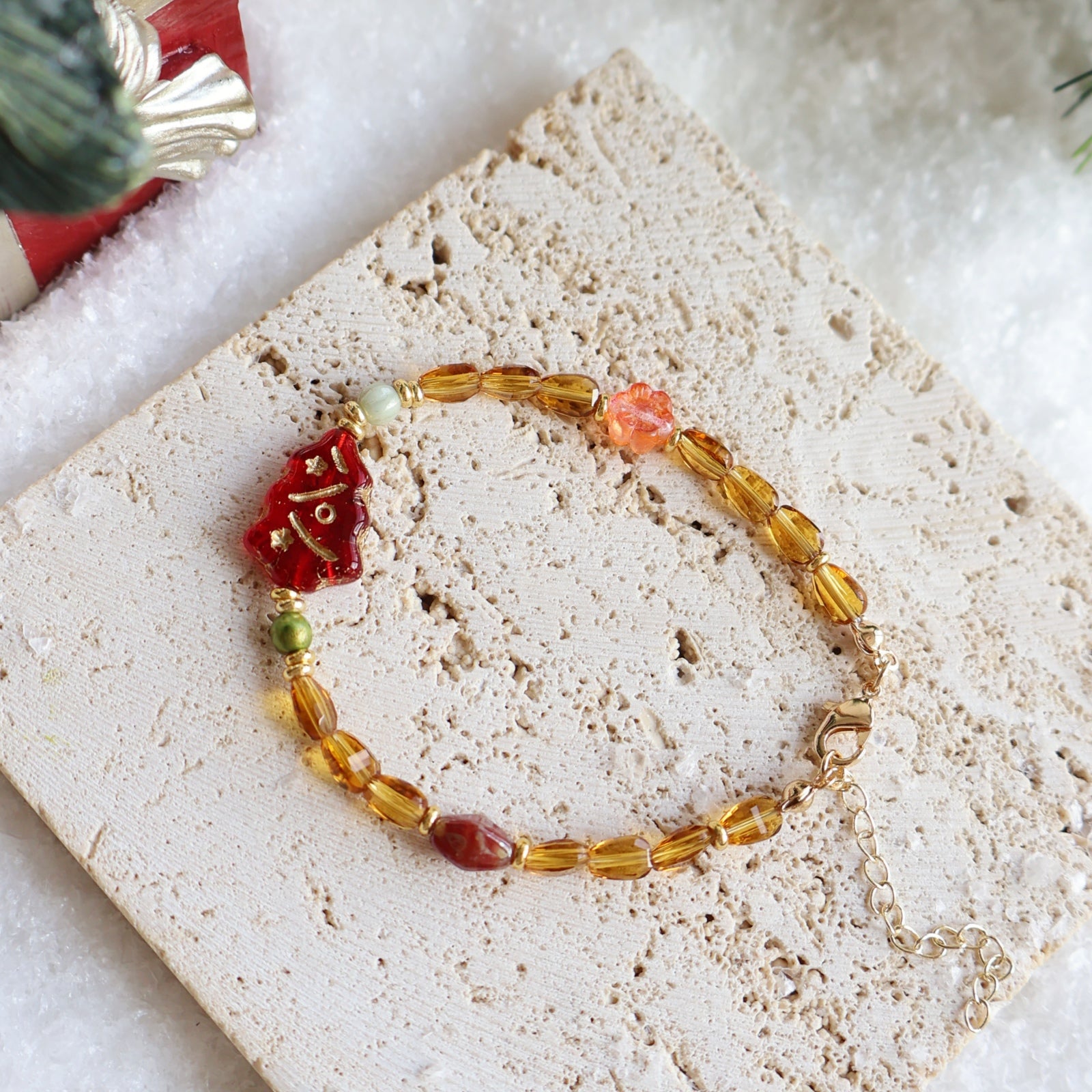 Bracelet with red and yellow beads on a textured surface