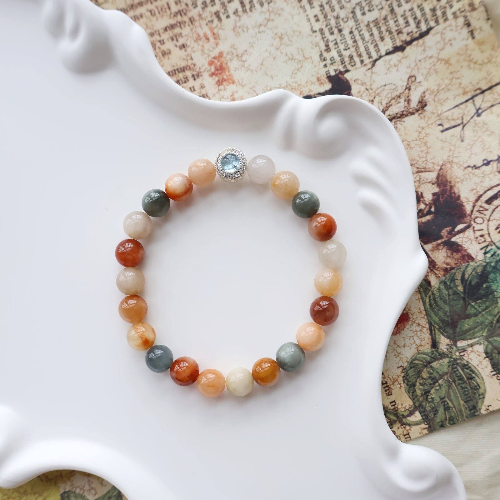 Multicolored beaded bracelet on a white shell with a vintage map background