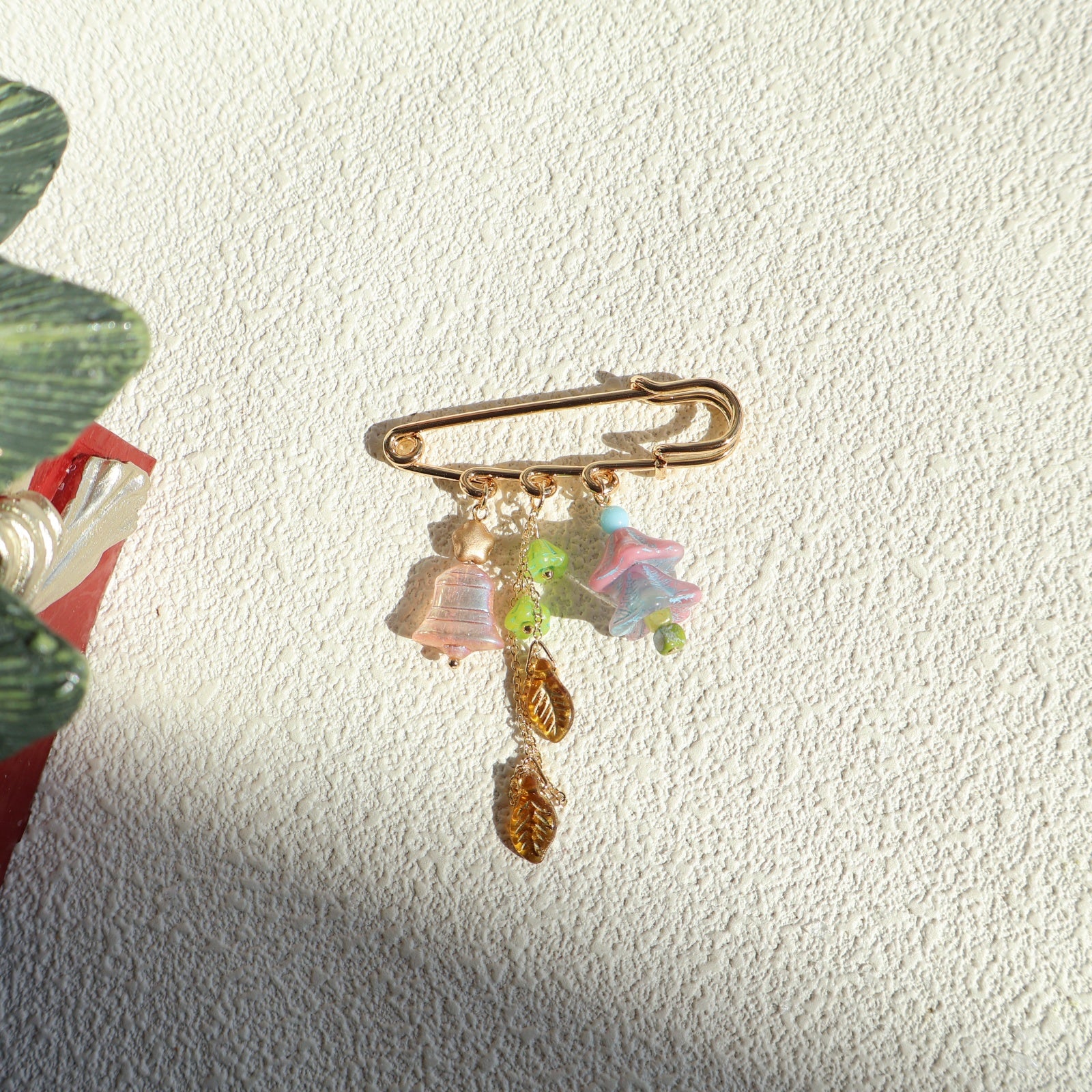 Decorative brooch with colorful elements on a textured white background