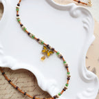 Necklace with butterfly pendant on a decorative white dish