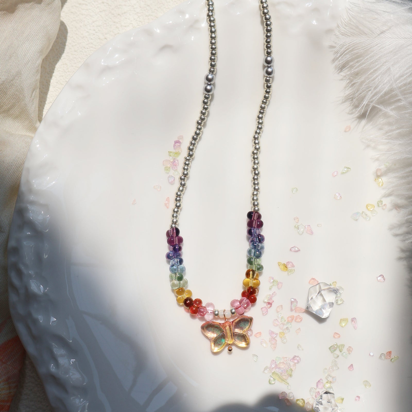 Necklace with a butterfly pendant on a decorative plate