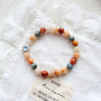 Multicolored beaded bracelet with a charm on a textured white surface