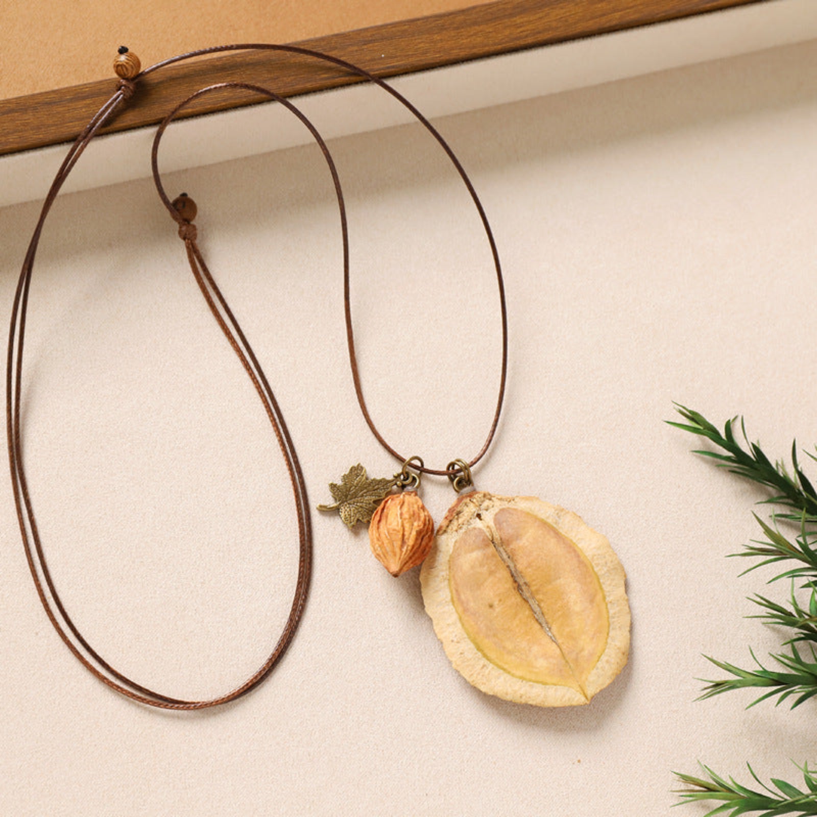 Necklace with natural pendant on a beige background