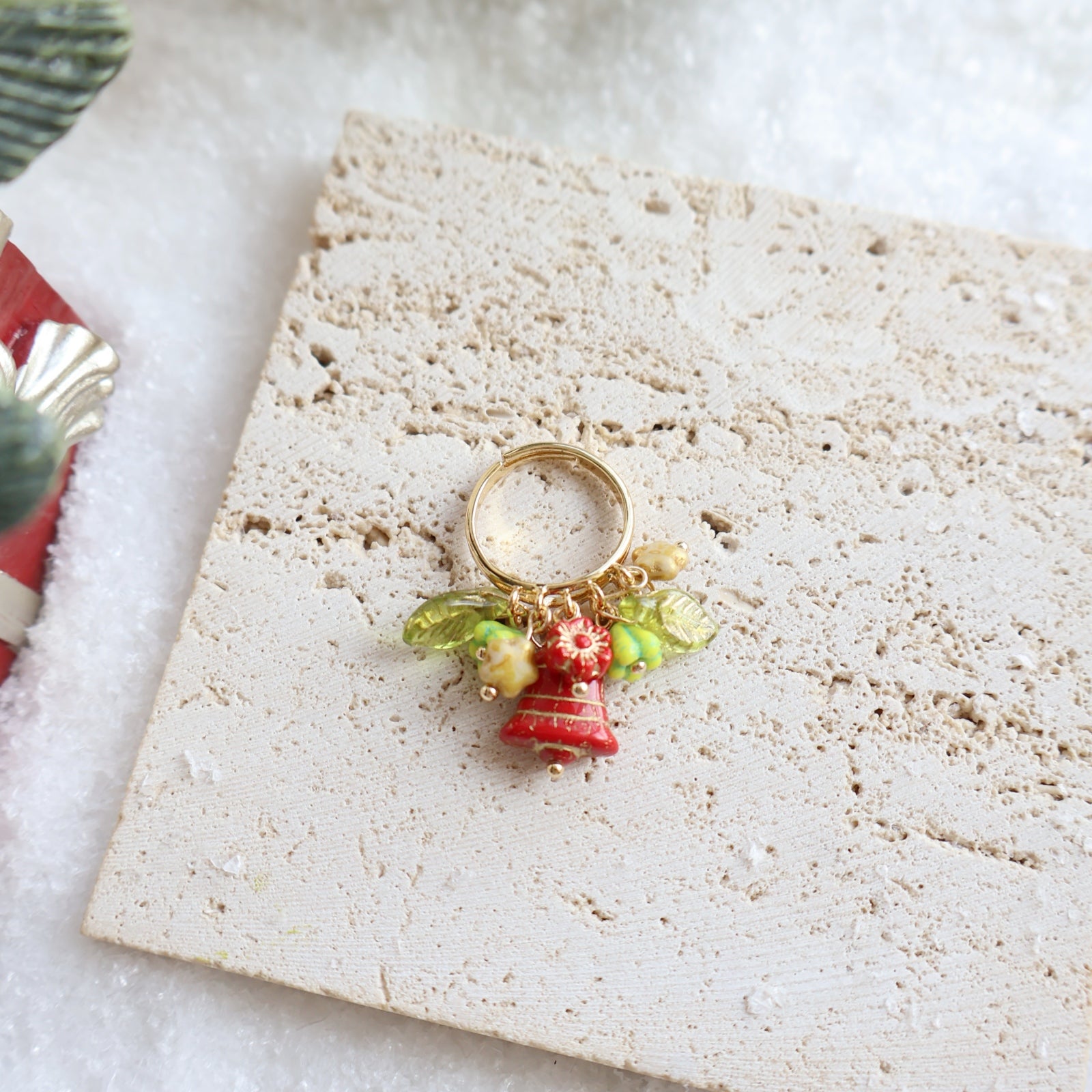 Decorative ring with charms on a textured surface