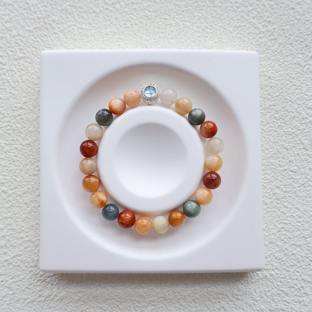 Multicolored beaded bracelet on a white dish with a white background