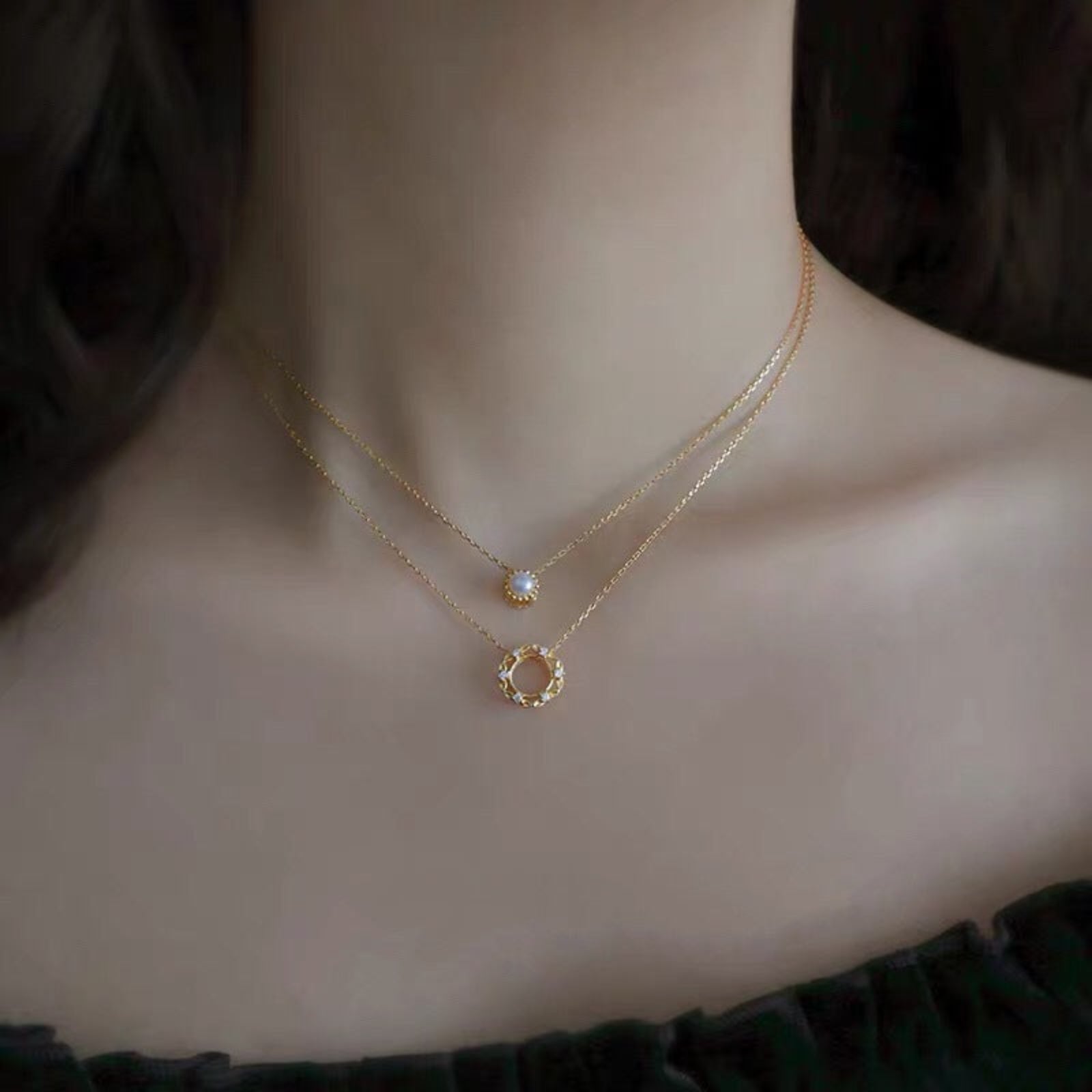 Gold necklaces on a mannequin with a dark background