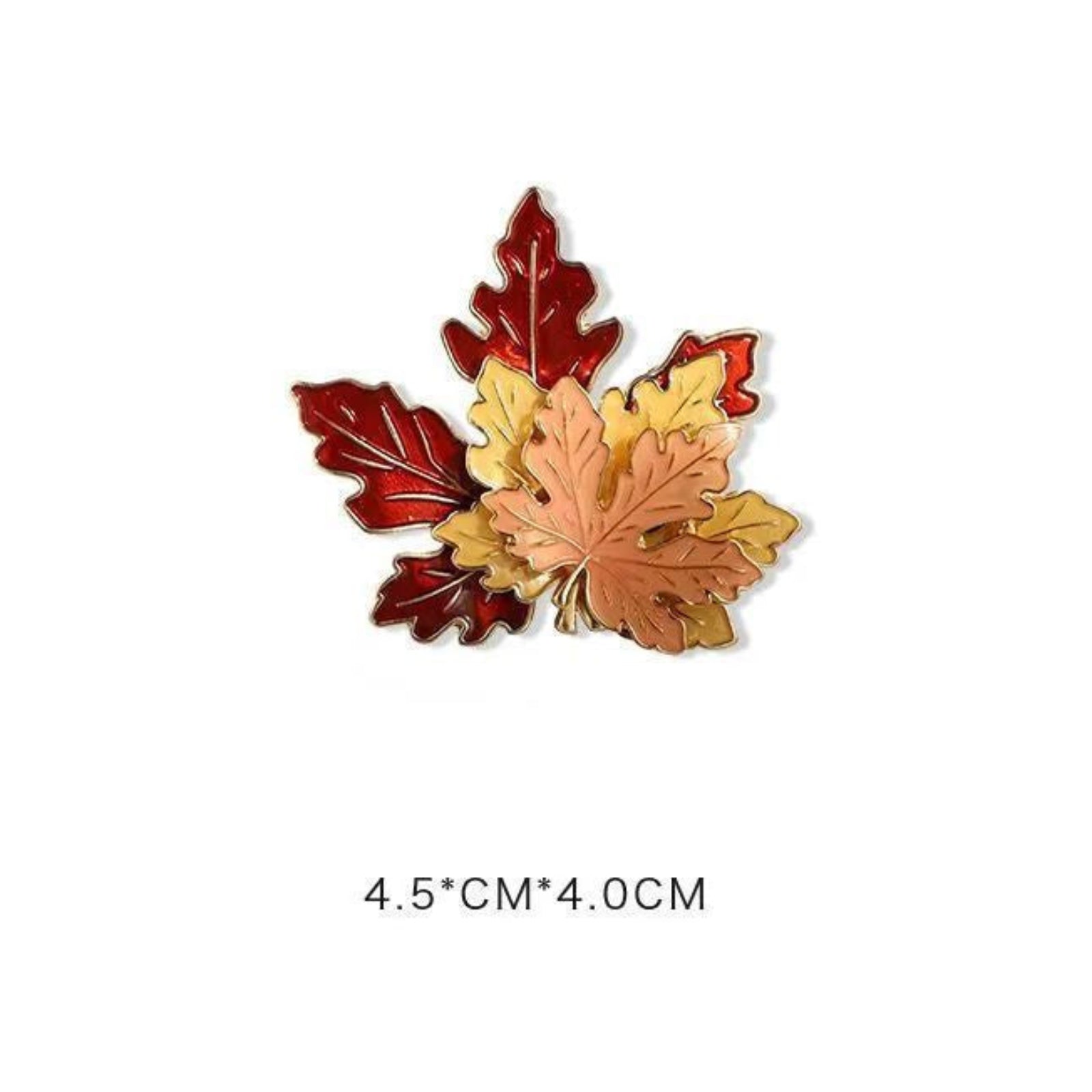 Maple leaf brooch with red and gold leaves on a white background