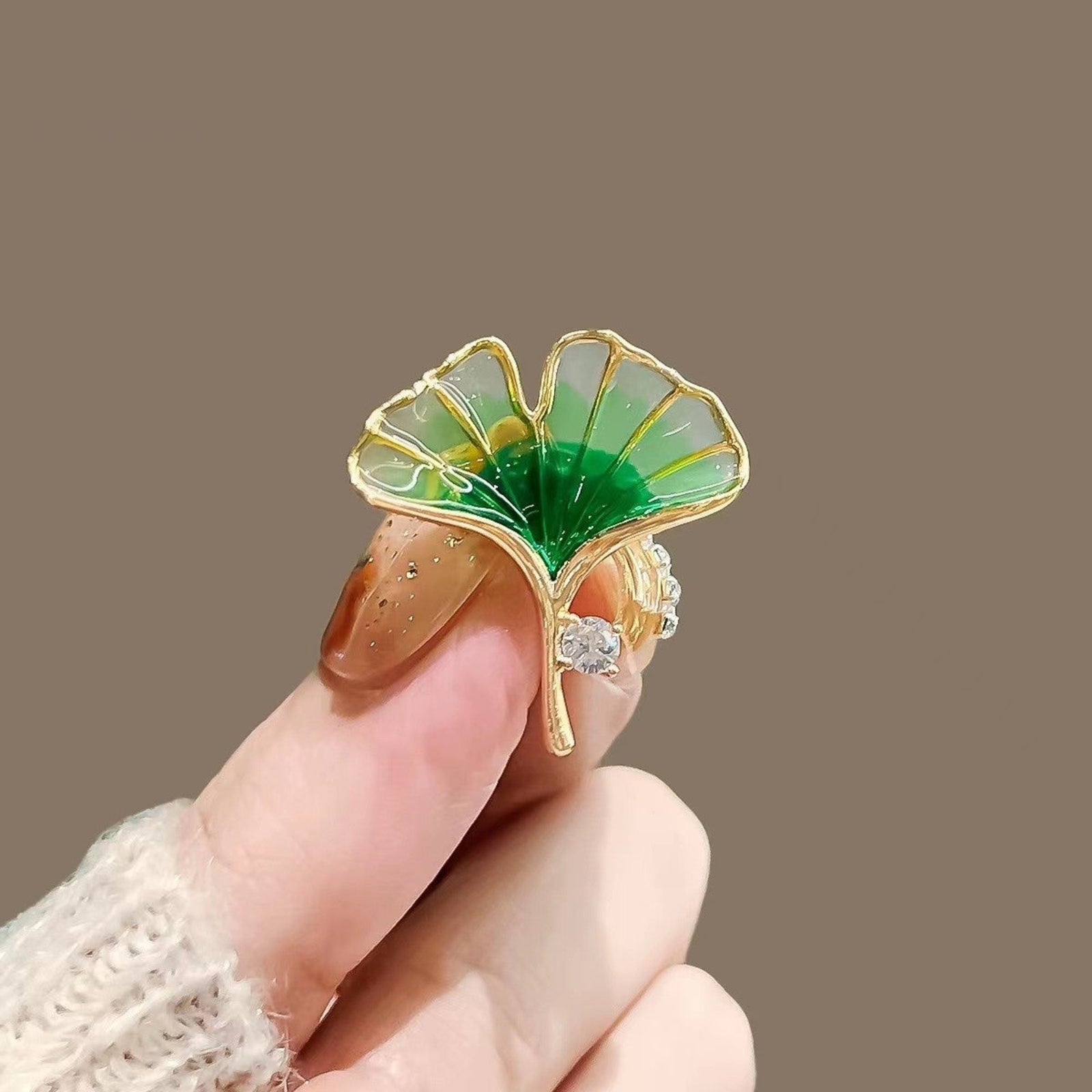 Gold green ginkgo held by a hand